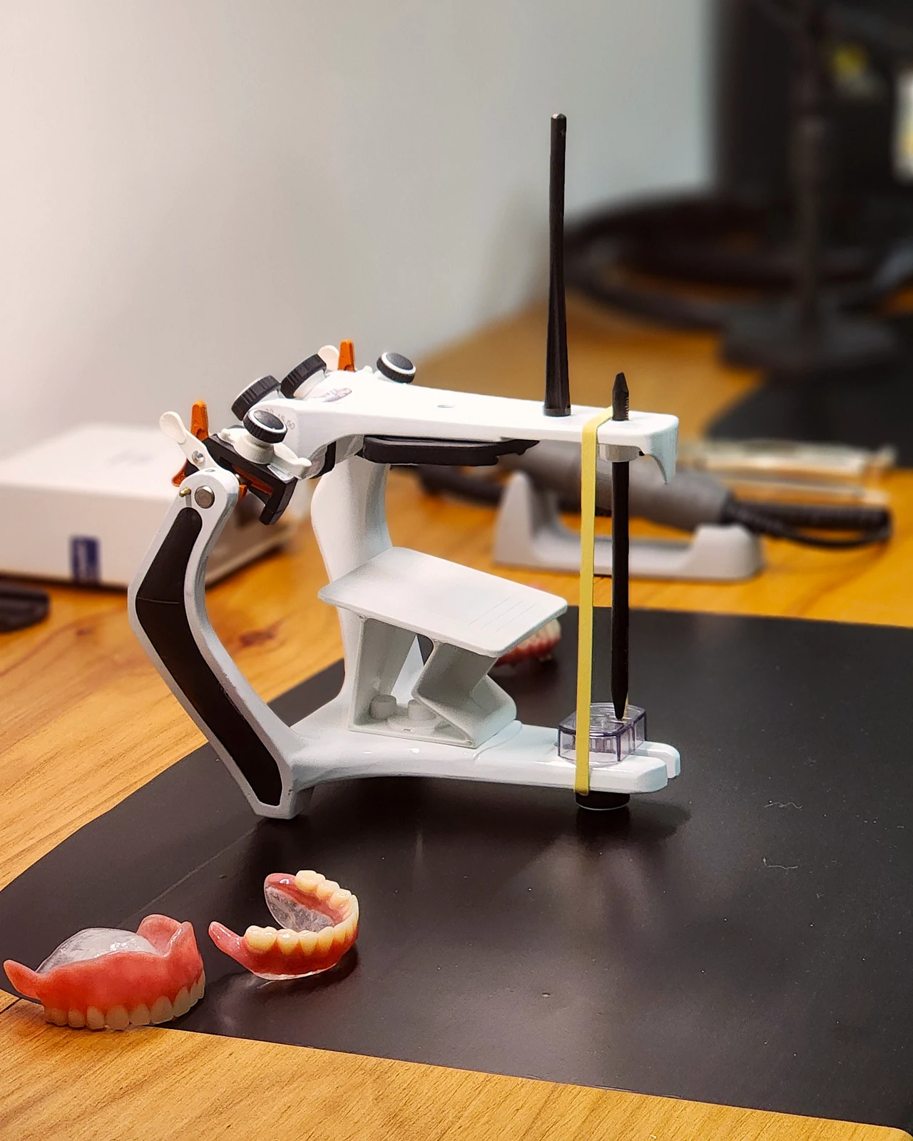 Articulador e próteses sobre a bancada do laboratório YAMASAKI
